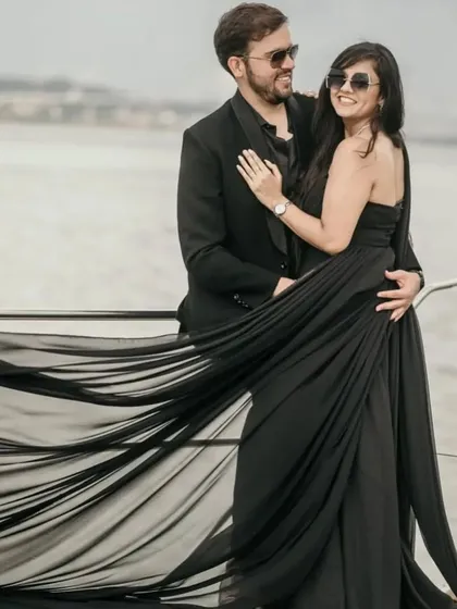 The long, flowing trails of our black gown create a stunning visual on this yacht photoshoot. It's a perfect choice for a chic and glamorous pre-wedding theme.