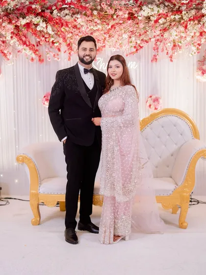 A classic engagement stage portrait of Shubham and Jyoti. This photo captures the couple against the beautiful floral backdrop of their celebration.