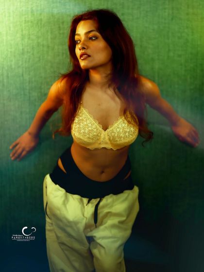 An artistic and moody portrait with creative gel lighting. The green light casts an ethereal glow, transforming a simple pose into something magical.