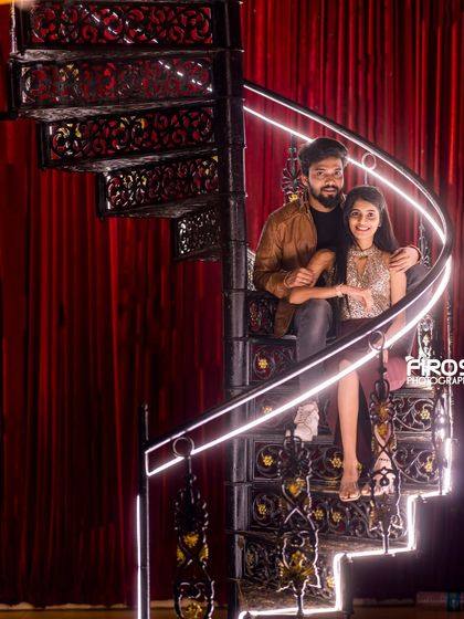 The illuminated spiral staircase offers a unique and elegant setting for a dramatic couple's portrait.