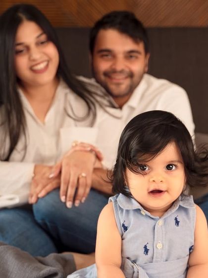 A sweet close-up of the baby while her parents smile in the background. This is a great way to capture the baby as the center of their world during an at-home session.