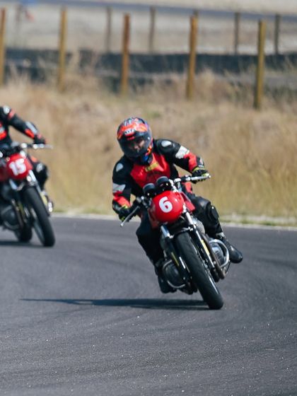 Two riders navigate a corner together, showcasing the group learning environment at our school.