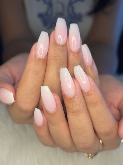 A full view of the classic milky white ombré nails.