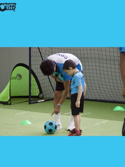 Our coach gives a young player a pointer on where to kick the ball. We use one on one instruction to ensure every child understands the basics of the game, building their skills and confidence with each tap of the ball.