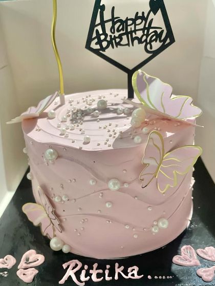 A lovely pink butterfly cake that's perfect for birthdays. The soft pink frosting is decorated with graceful butterflies and edible pearls, creating a delicate and feminine design.