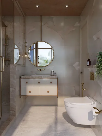 The vanity area in the guest bathroom is clean and modern, with a floating cabinet, a round mirror, and gold accents that tie in with the shower fixtures.