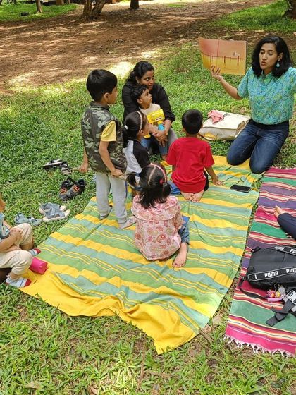 More moments of me reading to the group, using the book's illustrations to guide the story and capture the children's attention.