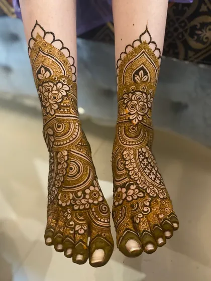 This intricate foot mehendi was done for my lovely bride, Afreen. The design perfectly matches the patterns on her hands, creating a complete and cohesive bridal look.