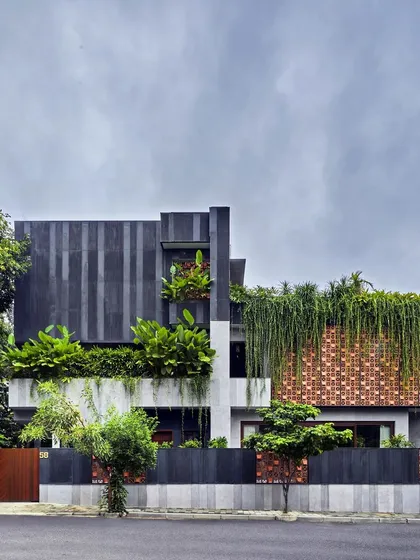 This private villa in Bengaluru showcases our concept of porous architecture, where the landscape becomes an integral part of the home. A facade of custom terracotta blocks and cascading greenery blurs the line between the built and the natural.