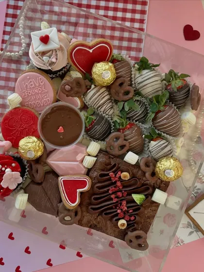 Fall in love with every bite. Our luxurious Valentine's Dessert Box is an explosion of treats, including chocolate-covered strawberries, fudgy brownies, heart-shaped cookies, and mini cupcakes.