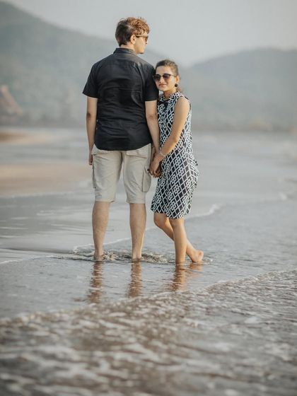 A gentle and romantic pose in the shallow waters of the beach. This kind of shot feels both intimate and connected to the natural surroundings.