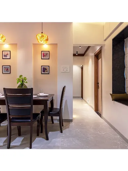A view from the dining area into the passage, showing the cohesive flow of the home. The warm lighting and consistent color palette create a harmonious journey from one room to the next.