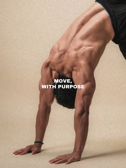 A client holds a downward dog position, a foundational yoga and movement pose that stretches the entire posterior chain. We believe in moving with purpose.