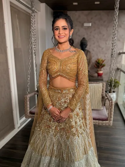 Golden hour glam. This stunning golden lehenga is paired with soft, shimmering eyes and a nude glossy lip for a look of pure sophistication.