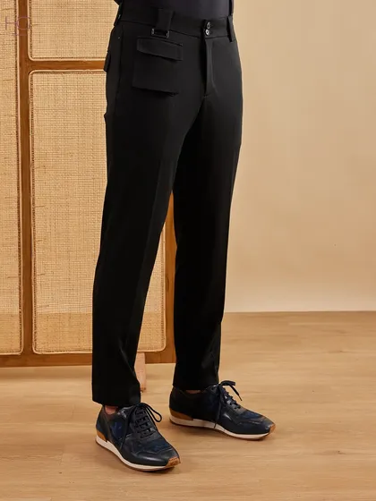 A simple layer can uplift your look from casual to classy. These tailored black trousers with a unique flap pocket detail are the perfect foundation for any smart-casual outfit.