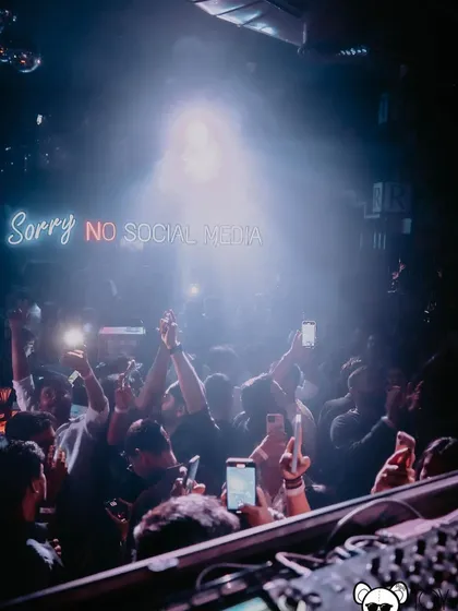 The crowd with their phones up, capturing the peak of the night. It's a modern sign of a truly memorable moment.