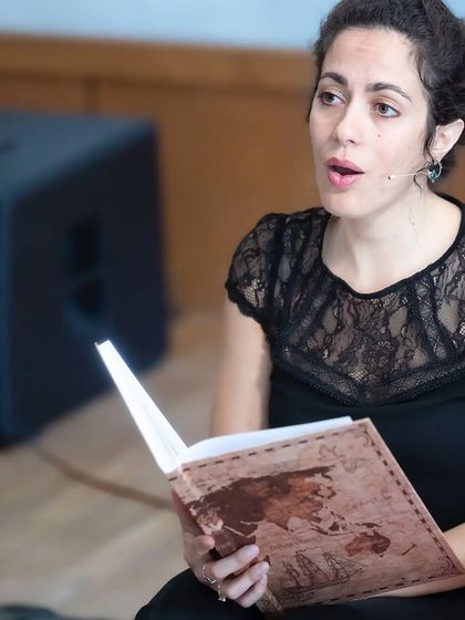 Our singer and artistic director reads from a storybook during the show. 'Pajarillo Verde' combines storytelling with world music to create a rich experience for children.