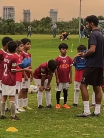 A coach gives a pre-game briefing to his team. These huddles are essential for discussing strategy and motivating the players.