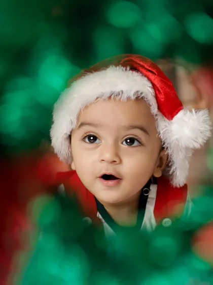 A creative shot through a Christmas wreath. We love finding unique perspectives to make your festive photos stand out.
