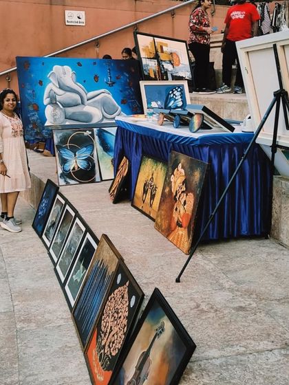 An artist with her collection of paintings at the 'Sublime Fiesta' art fair.