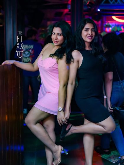 Friends posing for a photo while the party rages on. It's all about making memories on the dance floor.