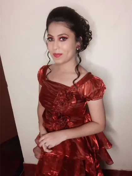 A full view of the party look. The makeup is bold yet elegant, and the hairstyle is designed to stay in place while she enjoys her event.