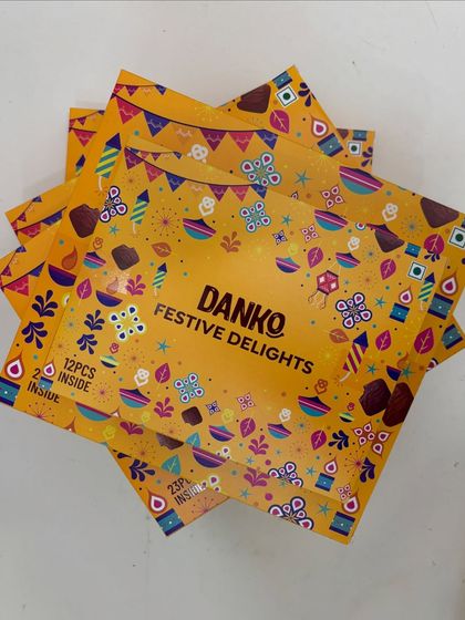 A stack of the Danko Festive Delights boxes, available in 12-piece and 23-piece options. They are a great, budget-friendly option for bulk festive orders.