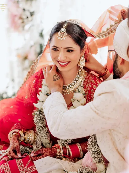 A sweet moment during the wedding ceremony, where the groom helps the bride with her jewelry. It’s these small acts of care that tell a larger story of their partnership.