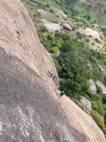 A wide shot showing two climbers on the massive face of Talai Betta. This gives a sense of the scale and adventure of our multi pitch routes.