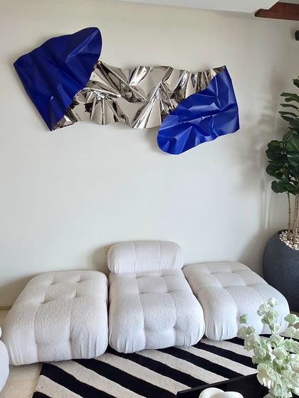 The full view of the silver and blue Meteor sculpture in its intended space, demonstrating how art can complete an interior design vision.