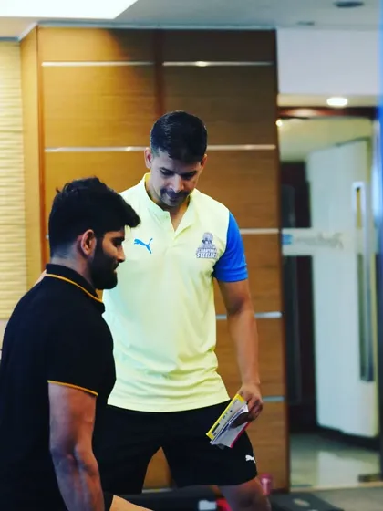 Reviewing the training plan with a player before his set. Every athlete has an individualized program.