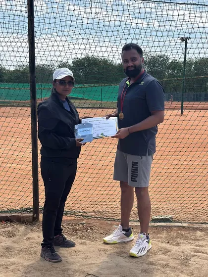 A coach awards a certificate to a semi finalist. We recognize and celebrate every stage of progress, encouraging players to keep pushing their boundaries.