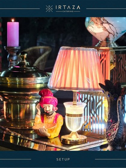Eclectic decor elements, like this small lamp and traditional figurine, are thoughtfully placed to add character and charm to the buffet table.