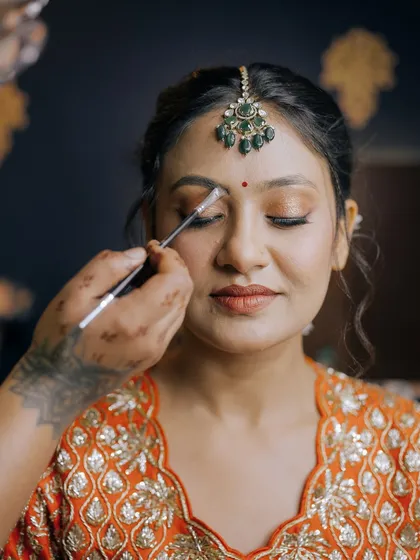 A behind-the-scenes shot of me defining the brows on a model. Perfecting eyebrows is a fundamental skill we focus on in my professional makeup course.
