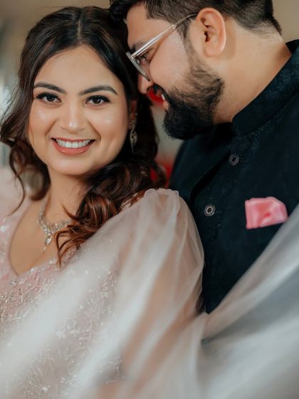 An intimate close-up of Gaurav and Mansi. Her radiant smile and his affectionate glance perfectly capture the love and excitement of their Roka ceremony.