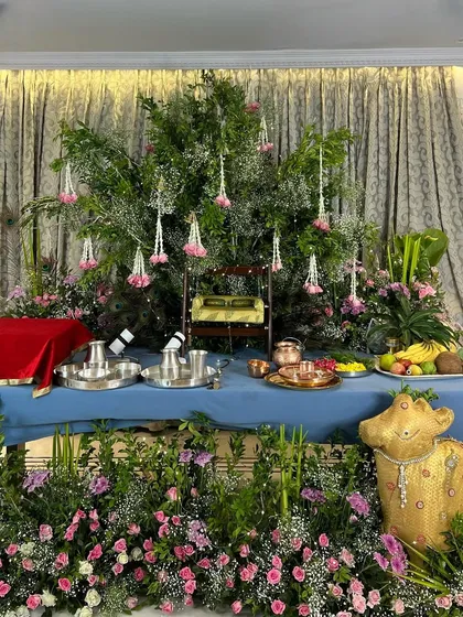 We created a lush, garden-like setting for this Janmashtami celebration, using a canopy of fresh greenery, hanging floral strings, and a traditional swing (jhoola) for Lord Krishna.
