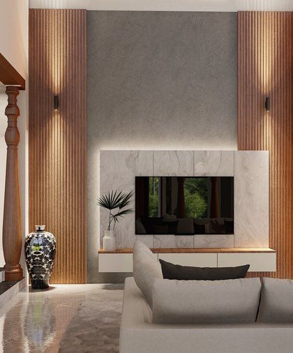 A detailed shot of the TV and shelving unit, highlighting the mix of vertical wood paneling, a marble accent, and warm, indirect lighting.