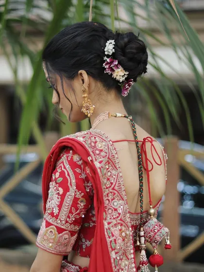 A bridal look is incomplete without the perfect hairstyle. This classic low bun, adorned with fresh flowers, is an example of the elegant and secure updos I create. It’s designed to hold the dupatta perfectly and last through all the ceremonies.