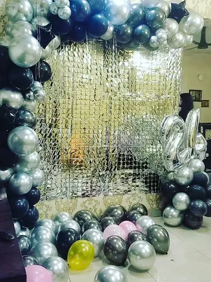 A still image of the 24th birthday balloon backdrop. The mix of metallic and chrome balloons creates a sophisticated and modern look for party photos.
