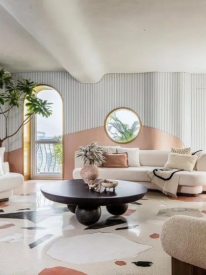 Another view of the living room, where the open layout and cohesive design language create the feeling of a large, uninterrupted volume.