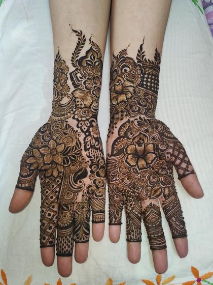 A classic semi-bridal design with beautiful floral work on the hands and forearms.