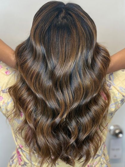 Soft waves, bold dimension. This hair flows with grace and glows with style, a true signature look.