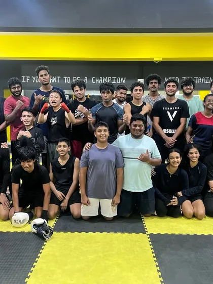 This is our family. A huge group of dedicated individuals, from beginners to seasoned fighters, all pushing each other under one roof. The words on our wall say it all: "If you want to be a champion, you need to train like one."