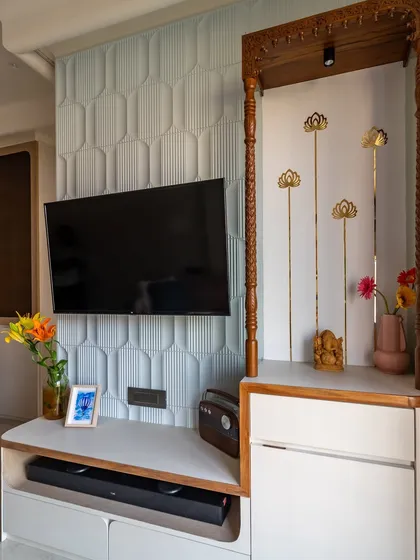 We seamlessly integrated a TV unit and a traditional temple space in this living room. The powder blue MDF panel adds a modern touch, while wooden pillars bring warmth.