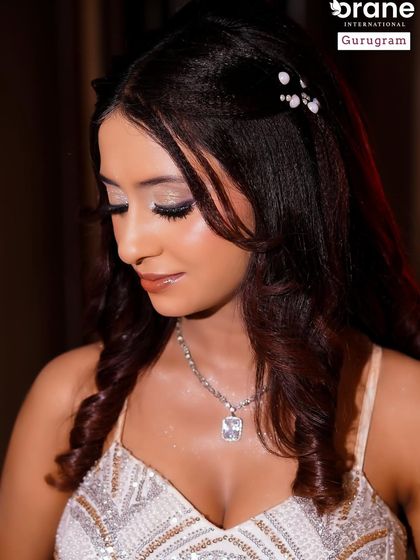 A close up of the soft glam makeup, showing the subtle shimmer on the eyes and the flawless skin finish. This is a popular and sophisticated style for evening events.