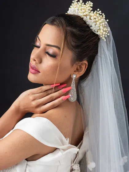 The side profile highlights the elegant hair accessory and the soft updo. We cover a variety of bridal hair accessories and how to secure them properly.