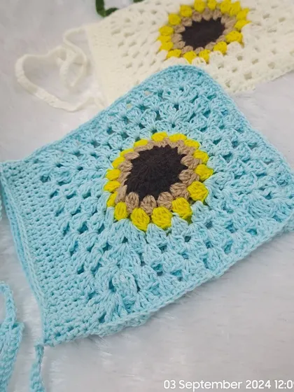 A closer look at the sunflower granny square design on my sky blue and white sling bags. The open stitchwork makes them light and airy.