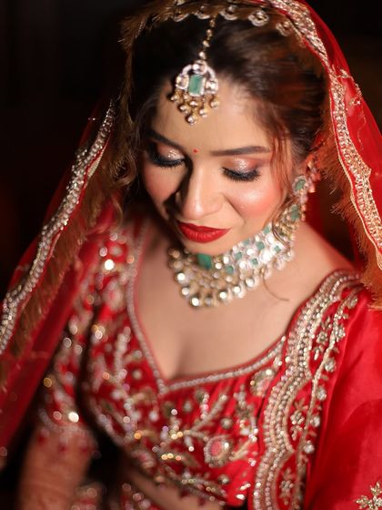 A close-up shot focusing on the glittery eye makeup and bold red lip. This combination is a classic for a reason, it's timelessly beautiful.