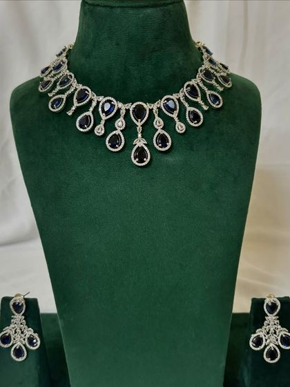 An American diamond necklace set with deep blue sapphire-like stones. This rental piece is perfect for adding a pop of colour to your evening wear.