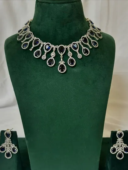 An American diamond necklace set with deep blue sapphire-like stones. This rental piece is perfect for adding a pop of colour to your evening wear.